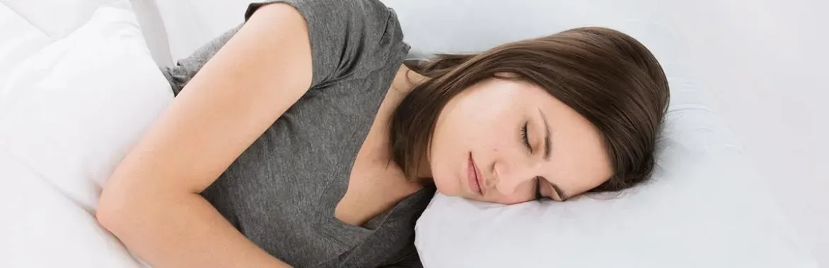 sleeping woman on white sheets